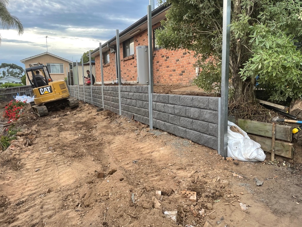 Residential construction site with retaining wall and excavation work