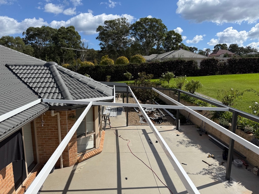 Residential rooftop deck under construction with site works below